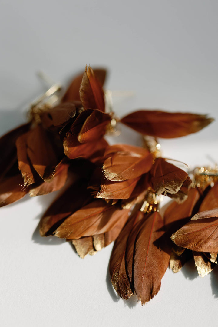 Statement earrings with caramel, gold-dipped autumn feathers